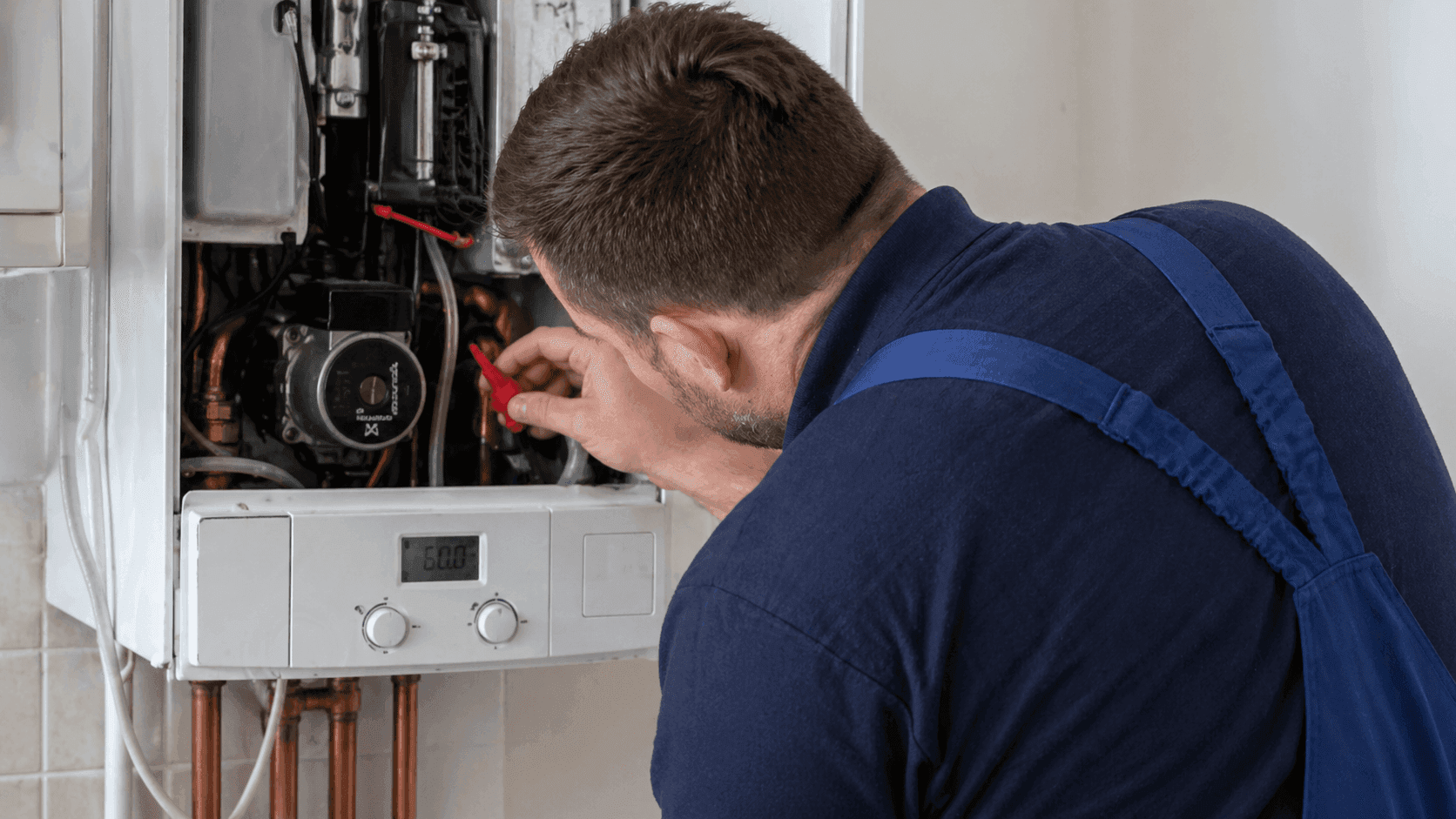 Heating engineer servicing a modern combi boiler